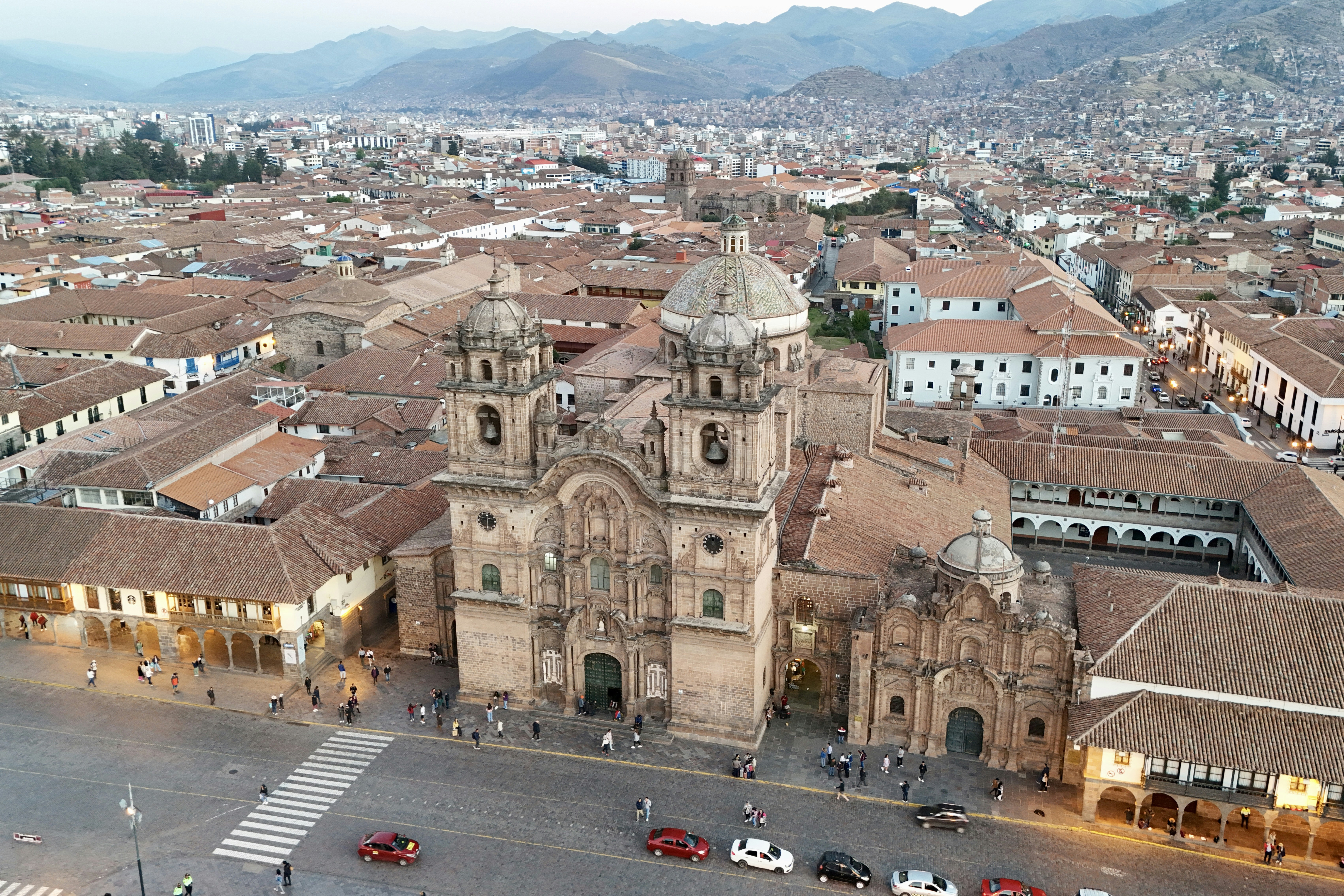 An aerial view of a city with a large cathedral