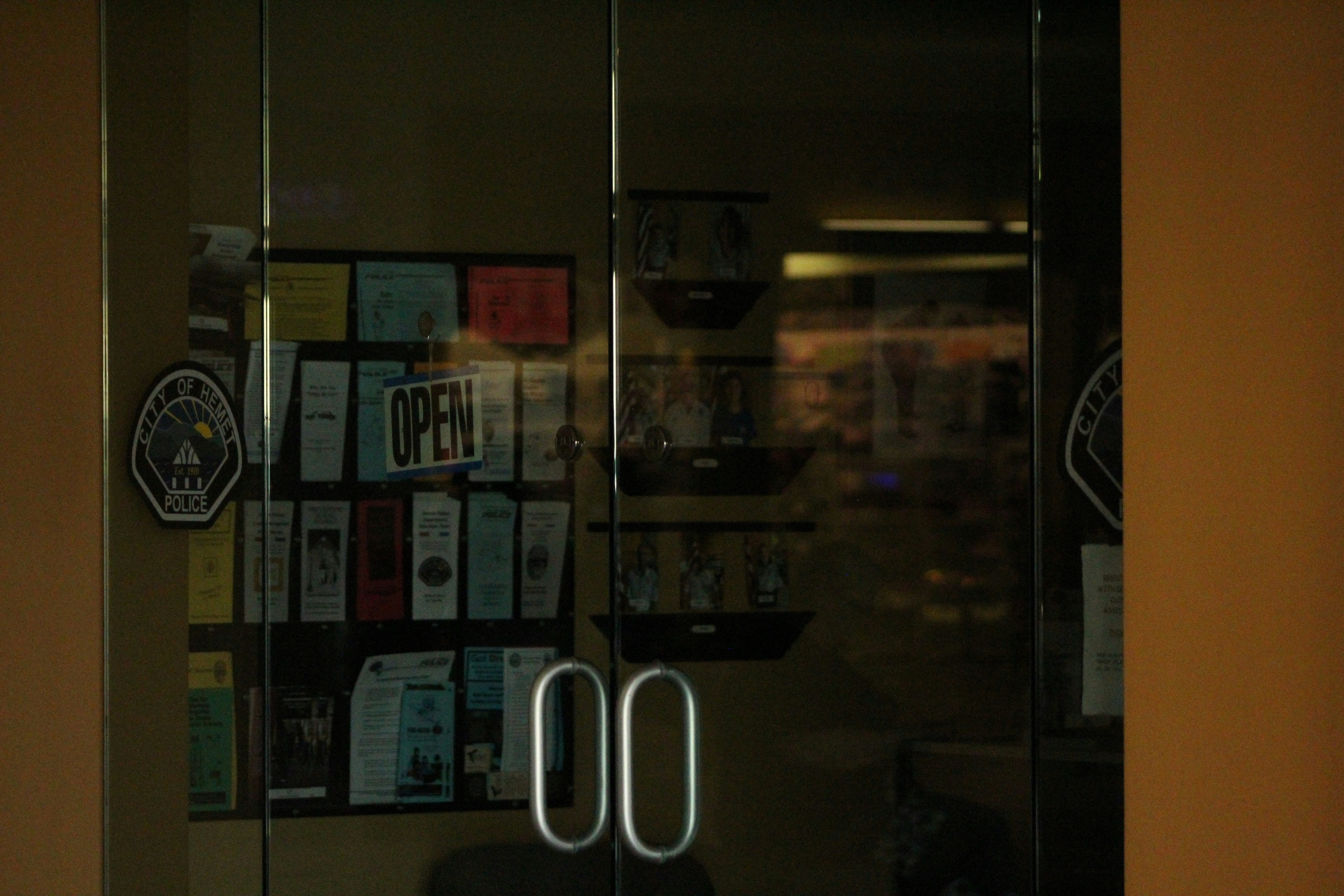 A glass door that has a bunch of stickers on it photo – Free Green ...