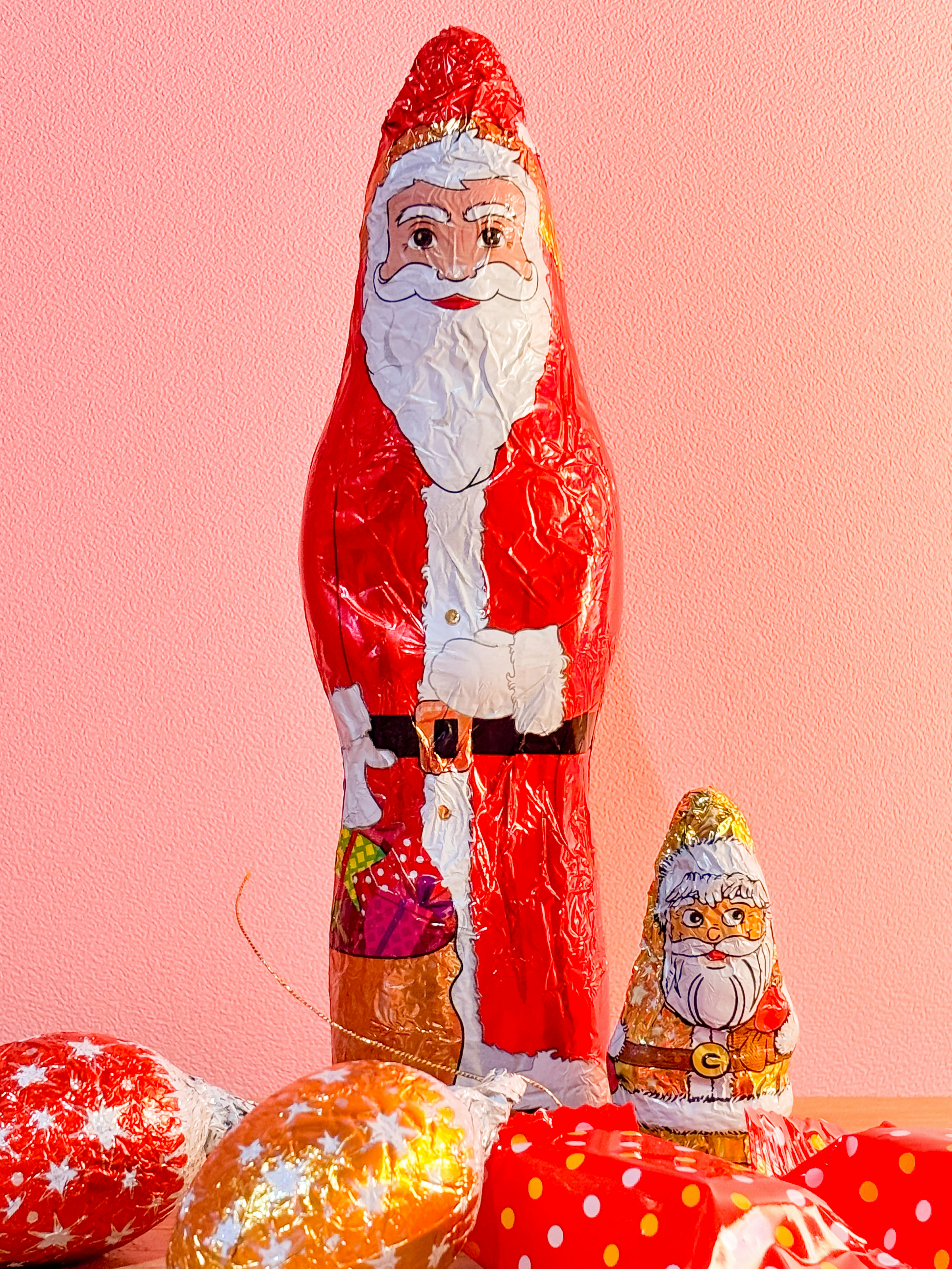A santa clause figurine surrounded by candy