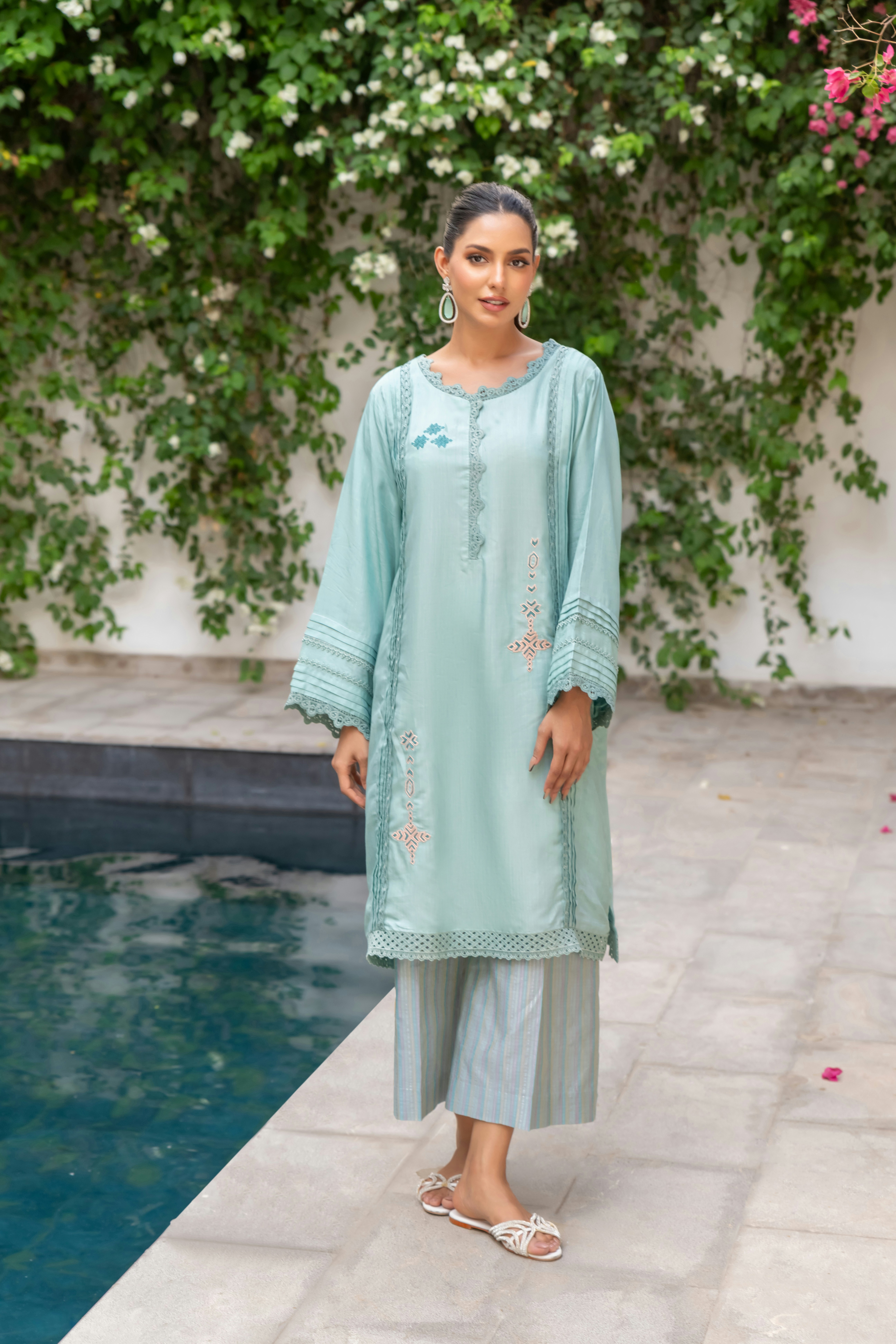 A woman standing in front of a pool