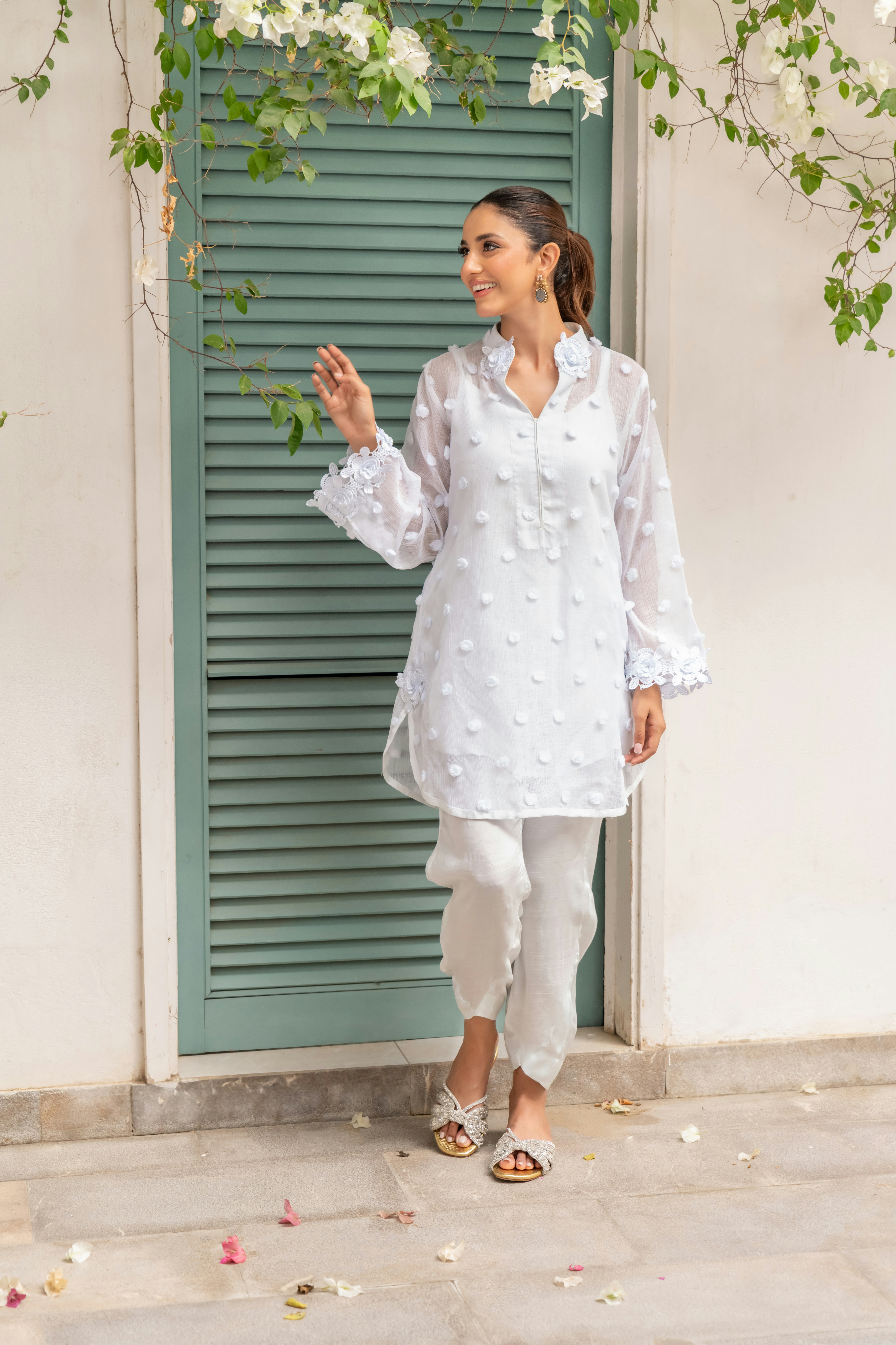 A woman standing in front of a green door
