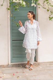 A woman standing in front of a green door