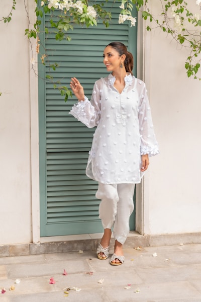 A woman standing in front of a green door