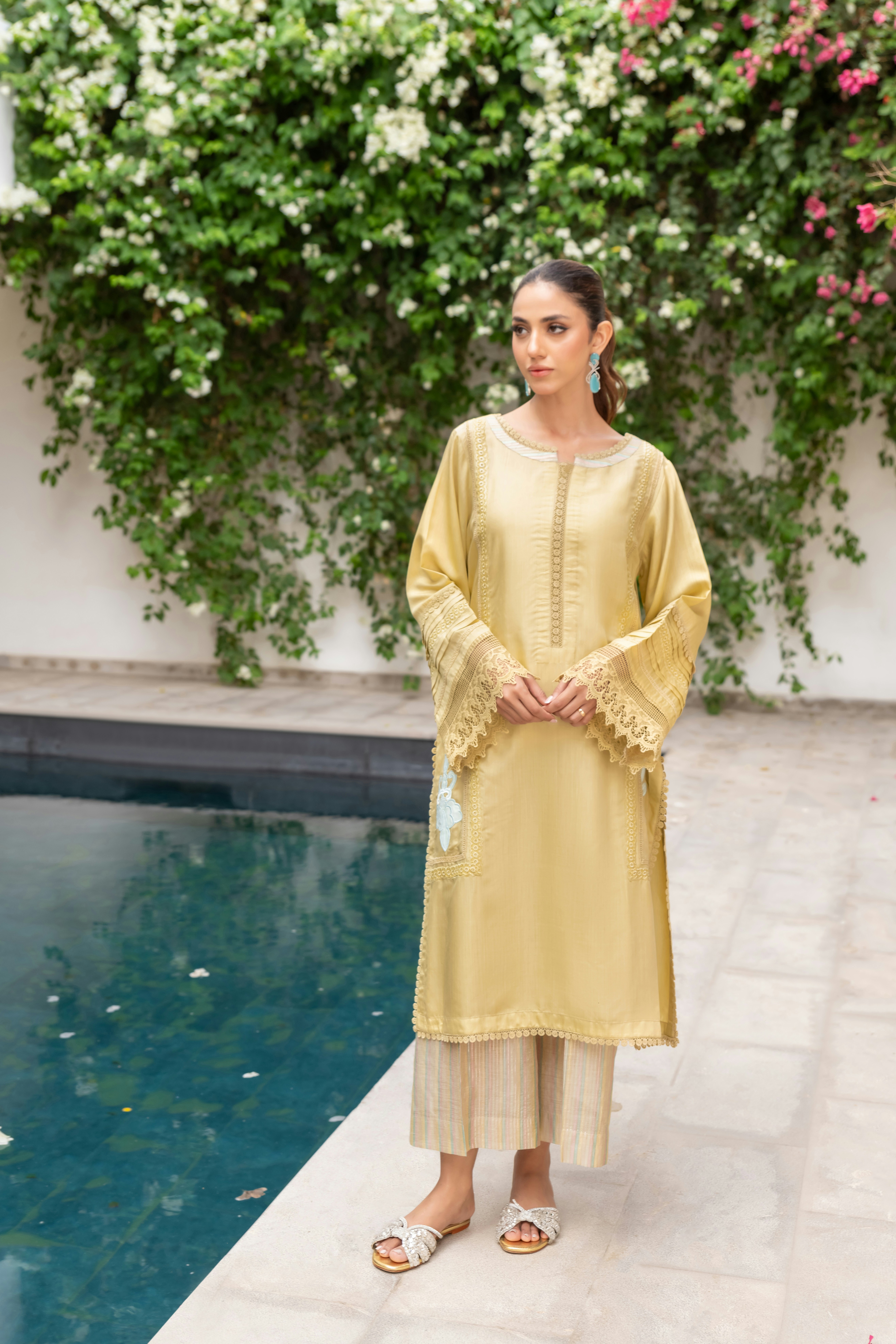 A woman standing in front of a pool