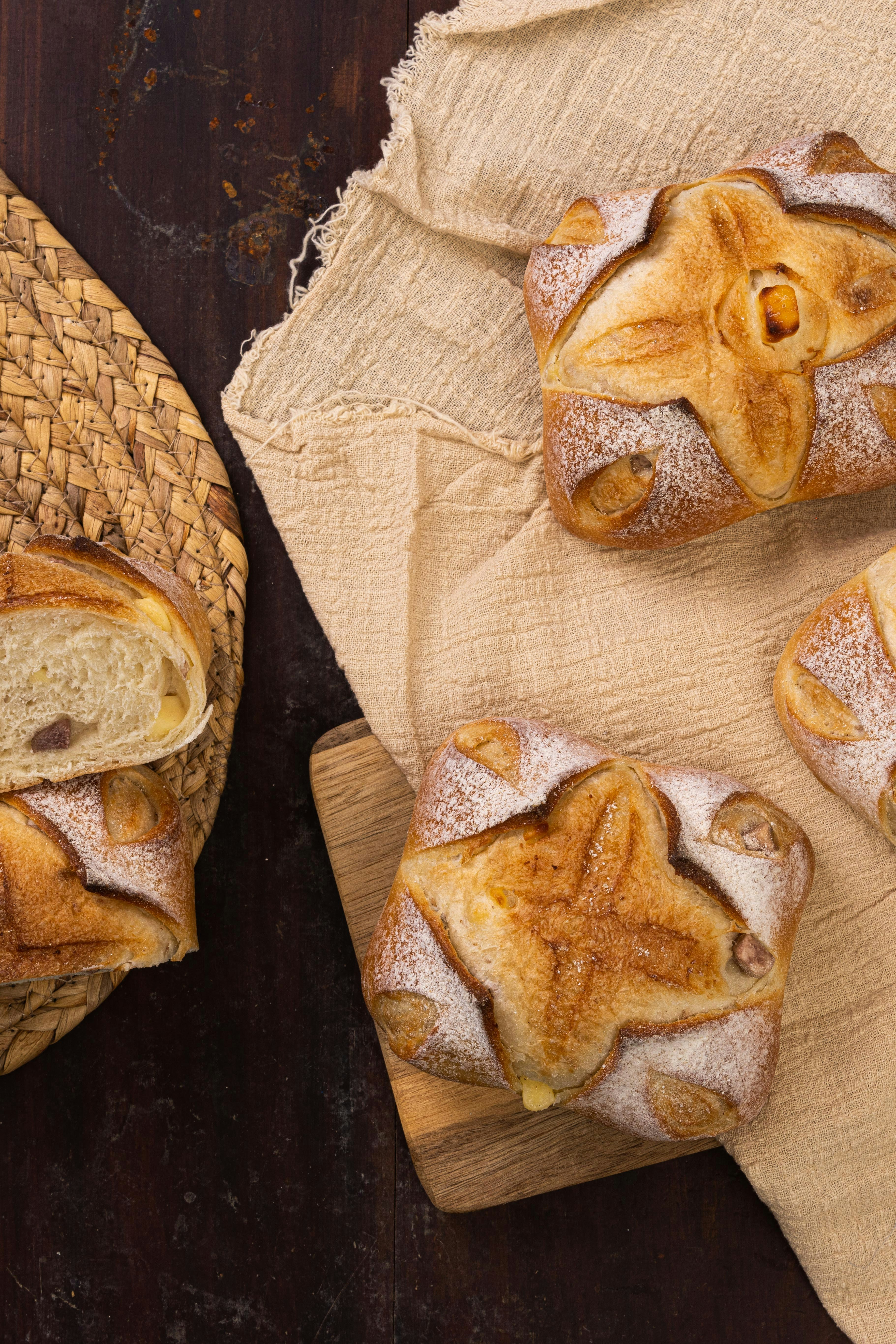 A wooden table topped with bread covered in icing