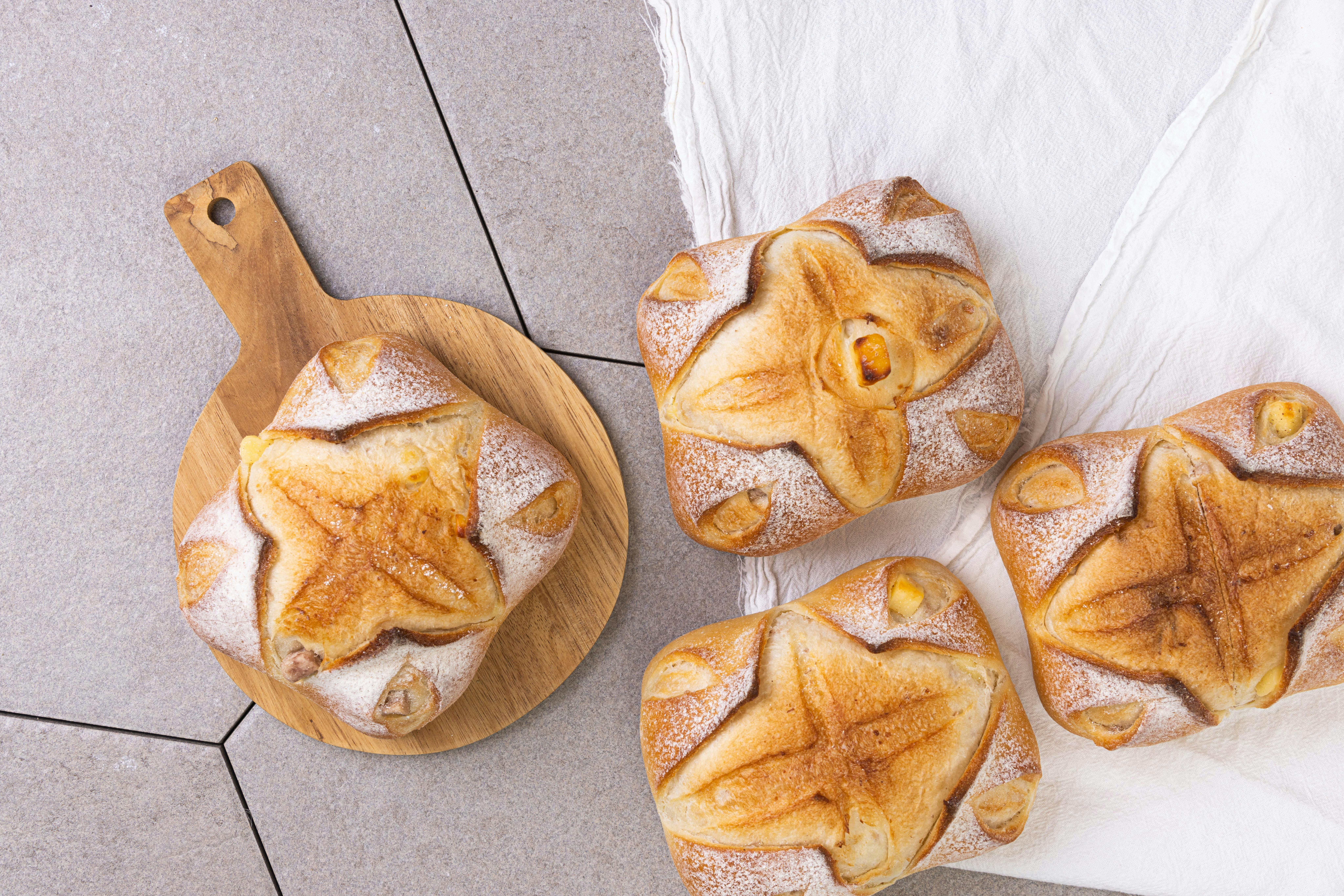 A group of pastries sitting on top of a wooden cutting board