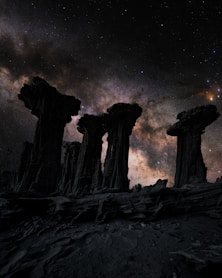 A group of pillars under a night sky filled with stars