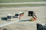 A group of buses sitting on top of an airport tarmac