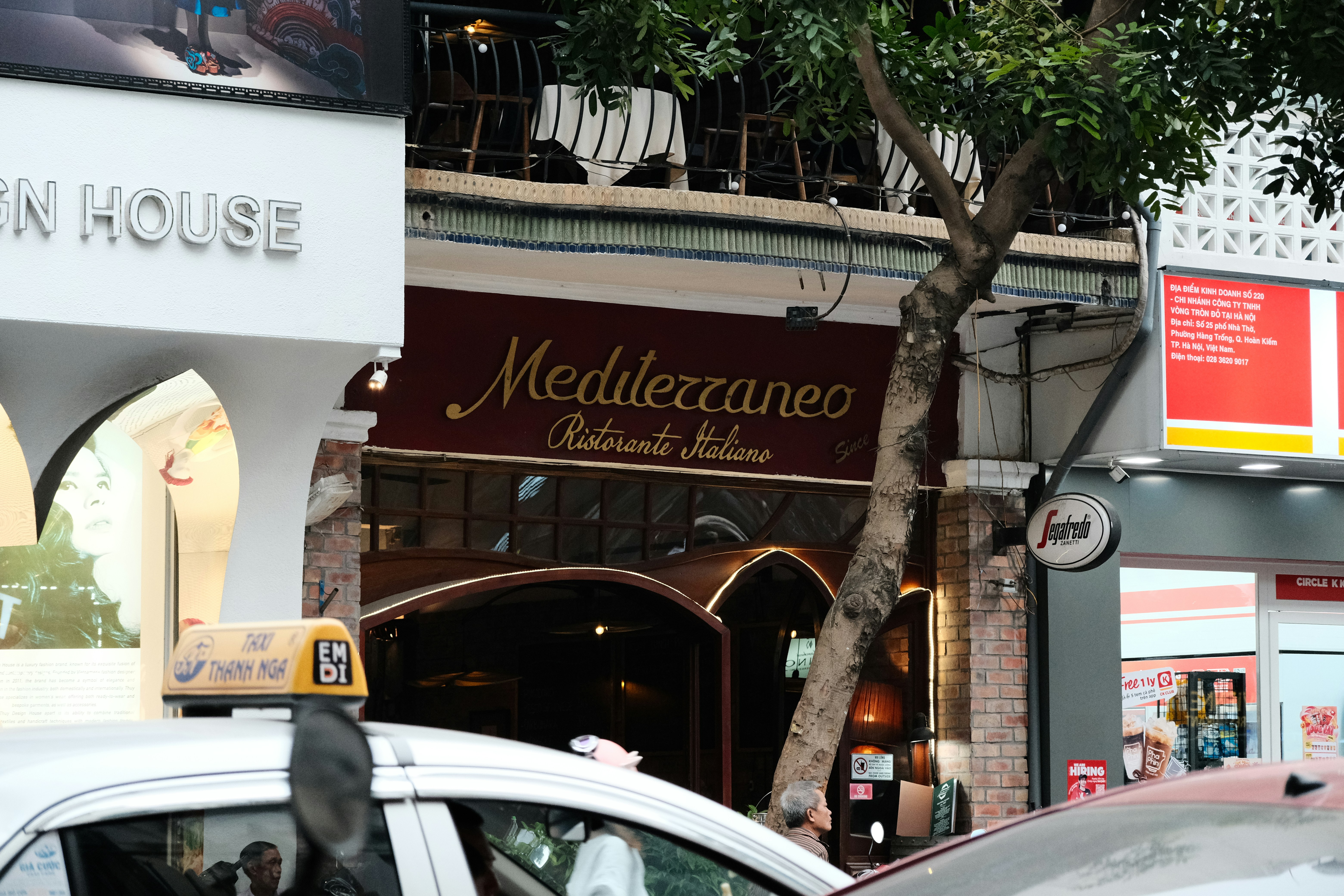 Taxi cab driving down a street