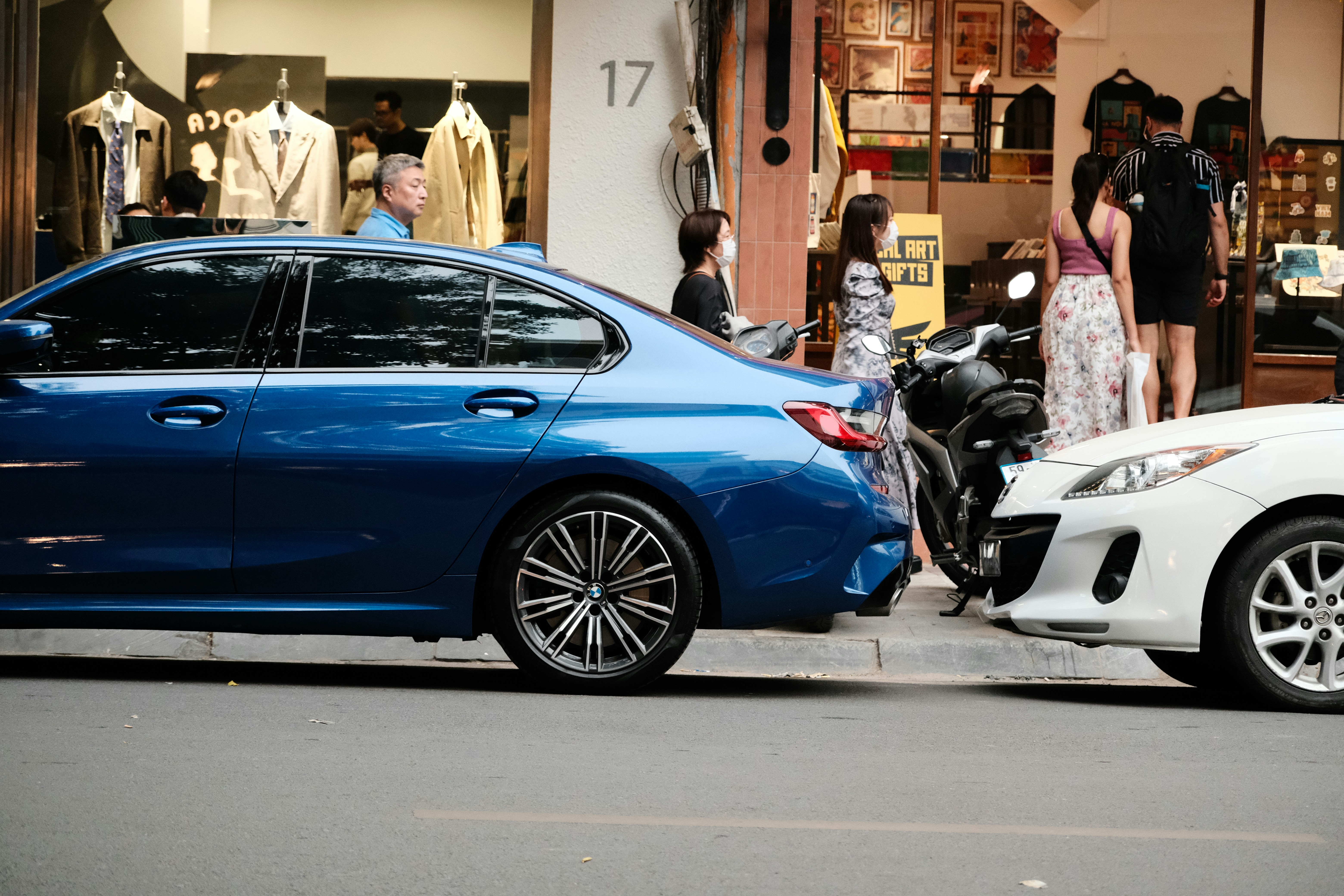 Salesperson using a tablet to walk an electric car buyer through battery information and pricing