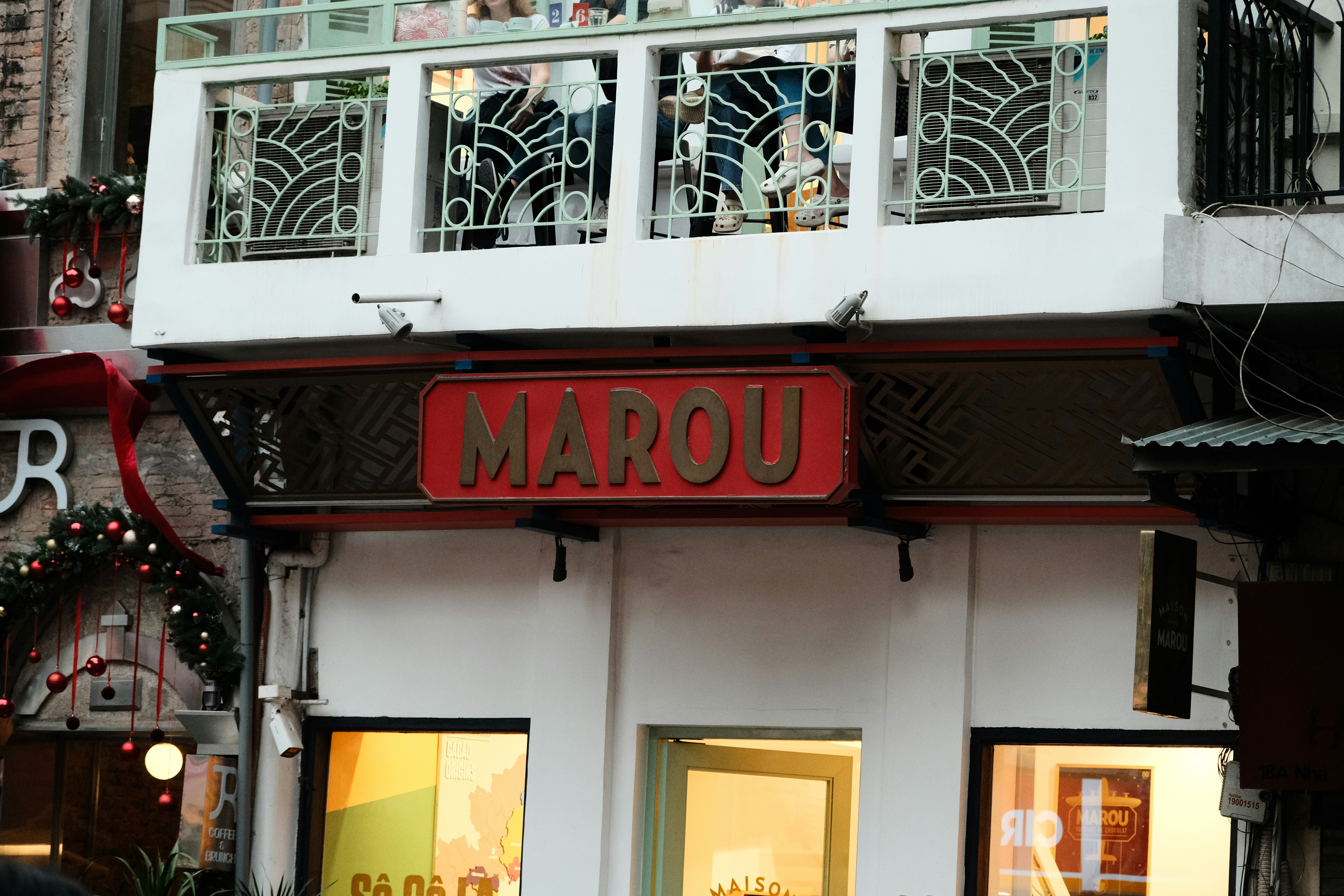 A group of people standing outside of a store