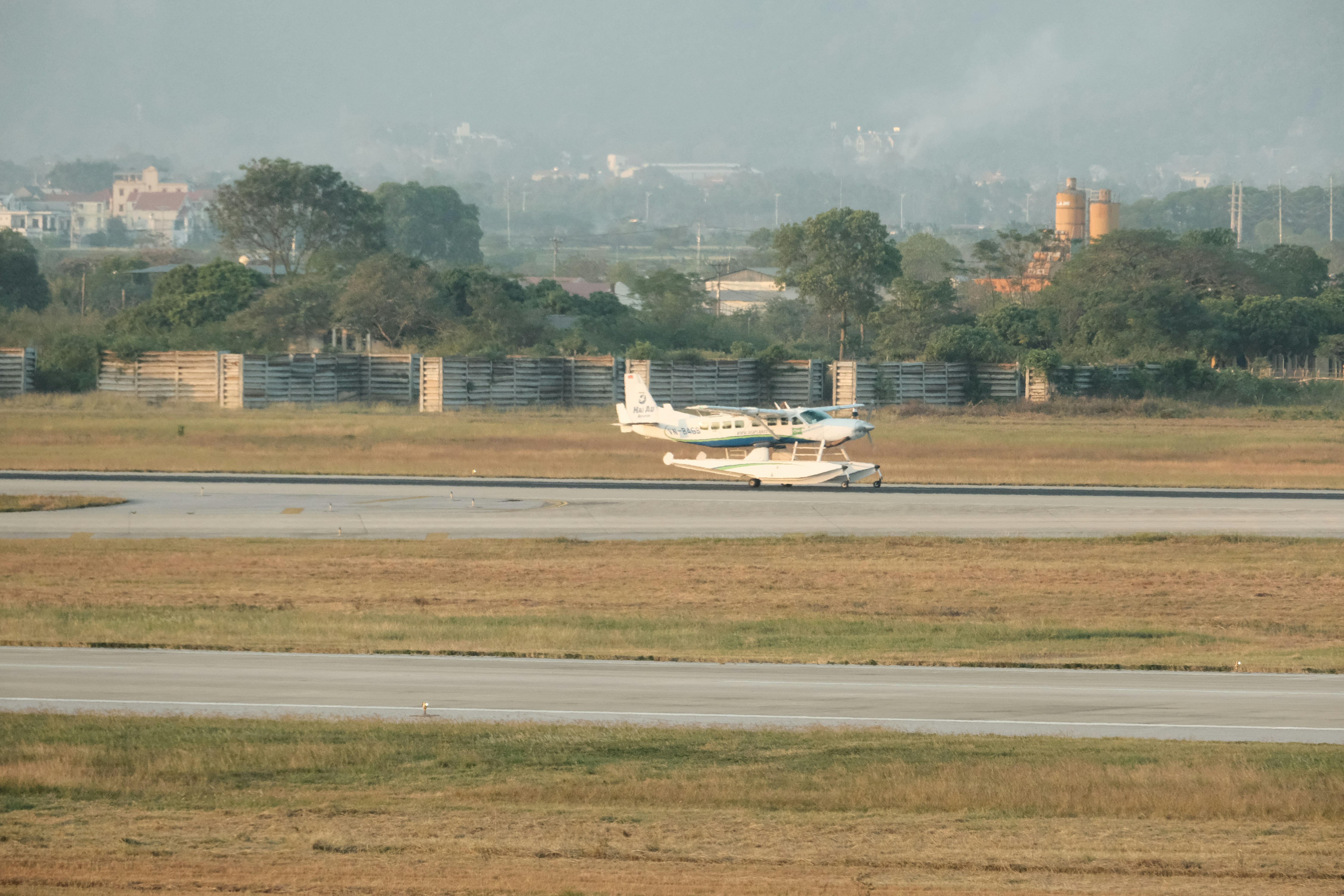 A small plane is on the runway of an airport, 