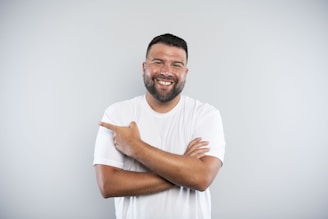 A man with his arms crossed smiling