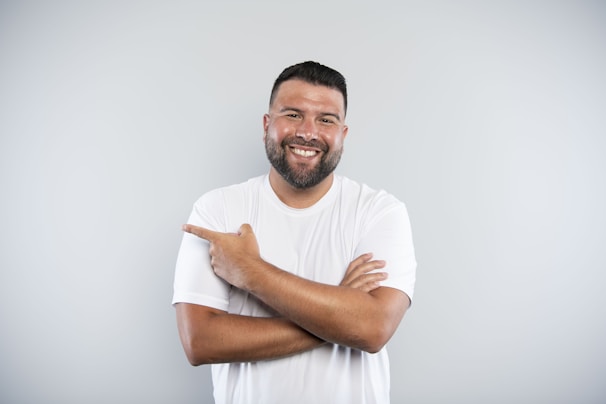 A man with his arms crossed smiling