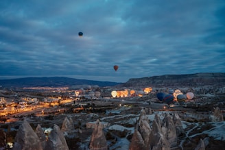 A group of hot air balloons flying over a city