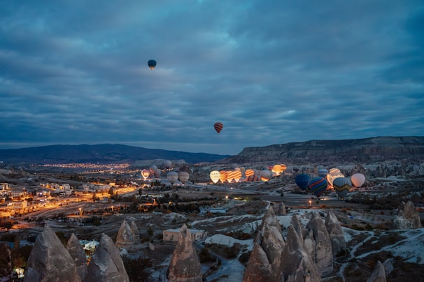 A group of hot air balloons flying over a city