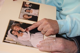 An older woman holding a picture of a young girl