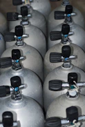 A bunch of propane tanks lined up together