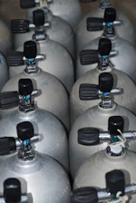 A bunch of propane tanks lined up together