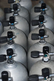 A bunch of propane tanks lined up together