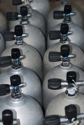 A bunch of propane tanks lined up together