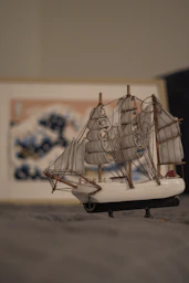 A model of a sailboat on a bed