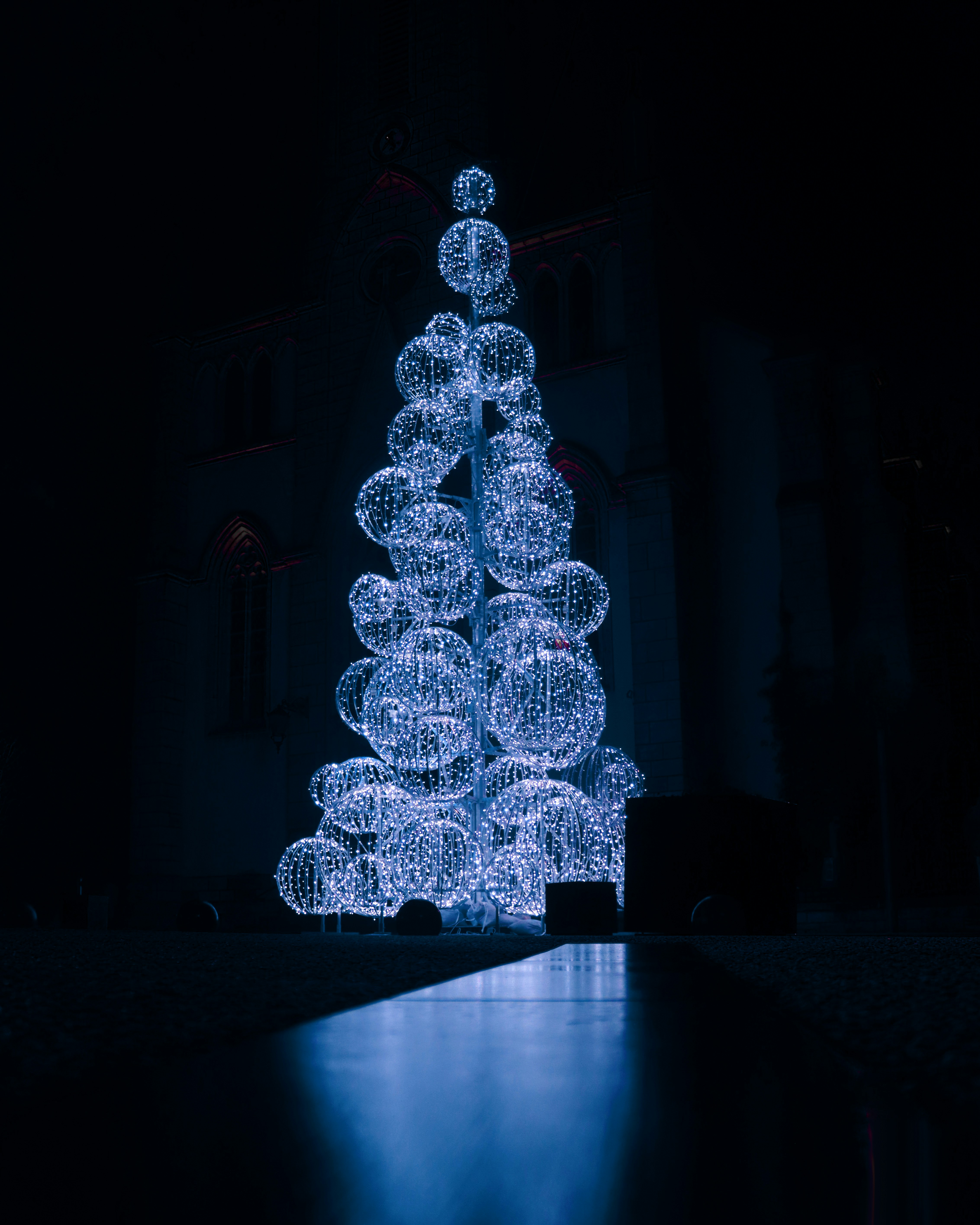 A lit up christmas tree in the dark