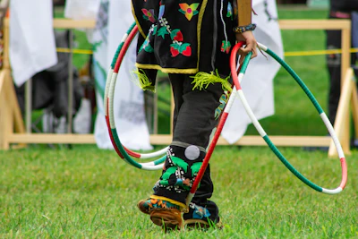 A young child with a pair of skis and a hula hoop