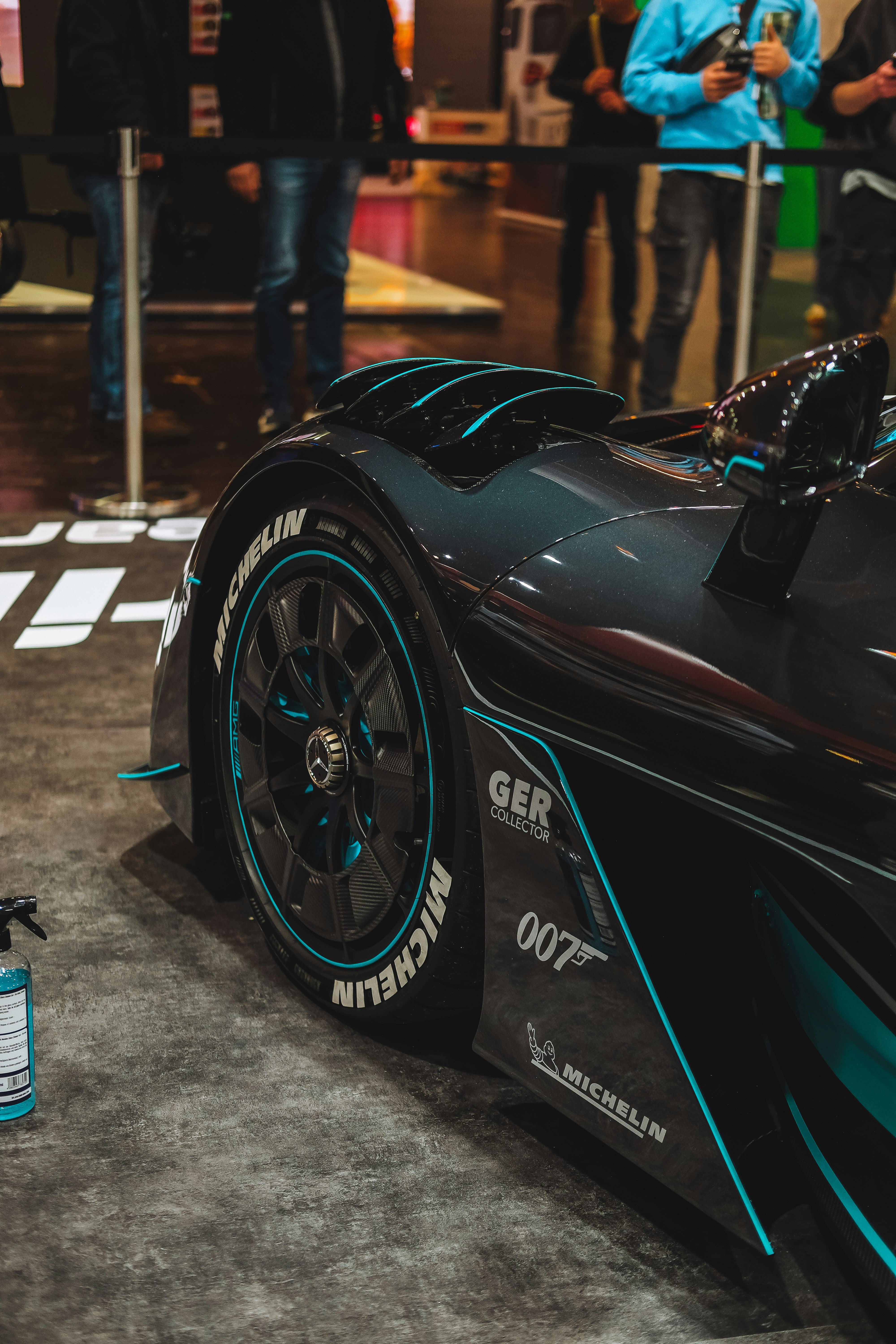 A black and blue race car on display at a car show