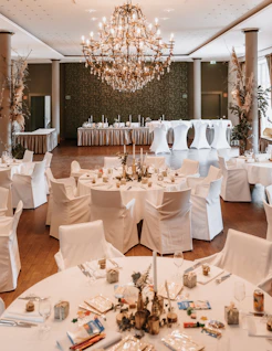 A room filled with tables and chairs covered in white linens