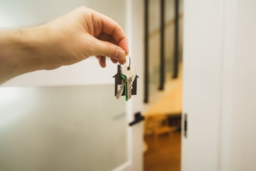 A hand holding a key to a door