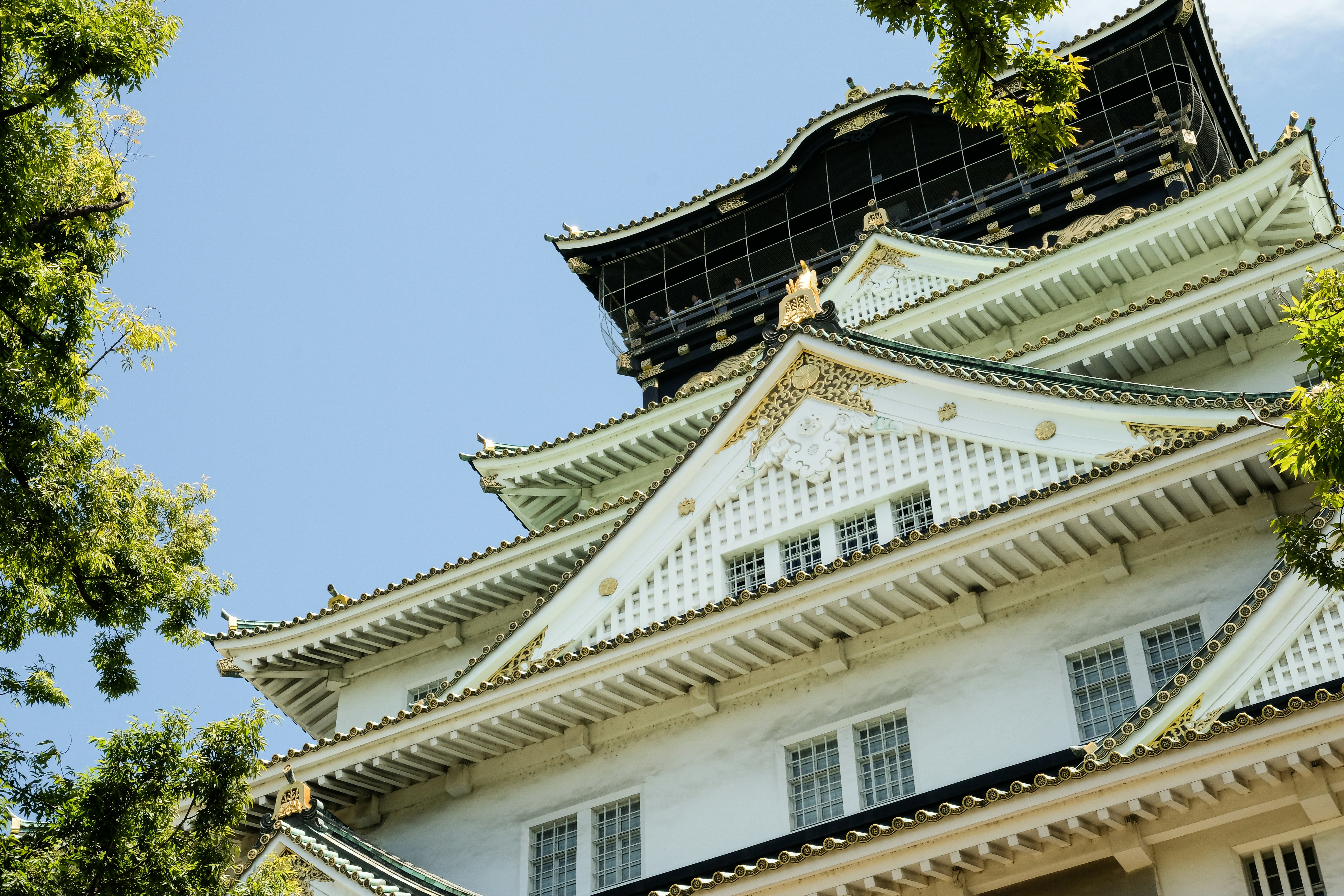 A tall white building with a black roof