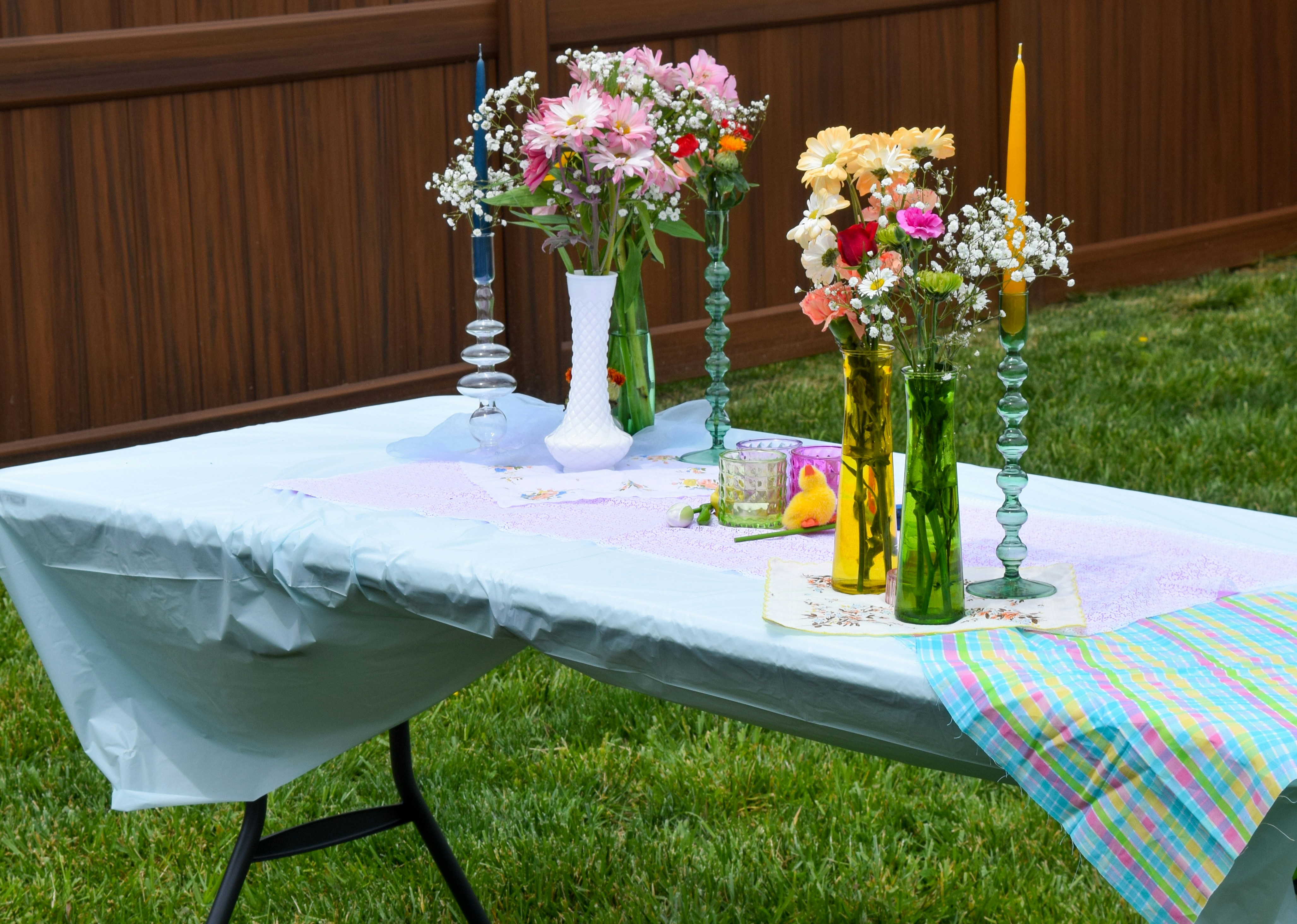 A table topped with vases filled with flowers