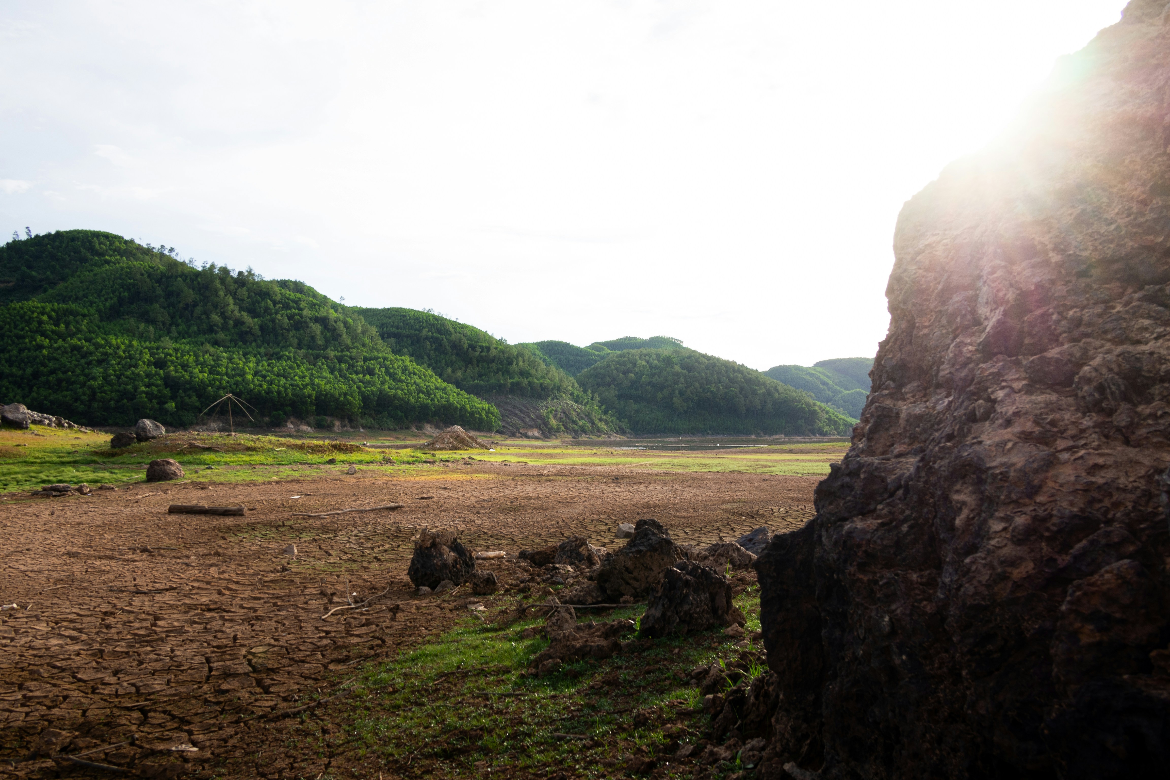 The sun shines brightly on a rocky outcropping