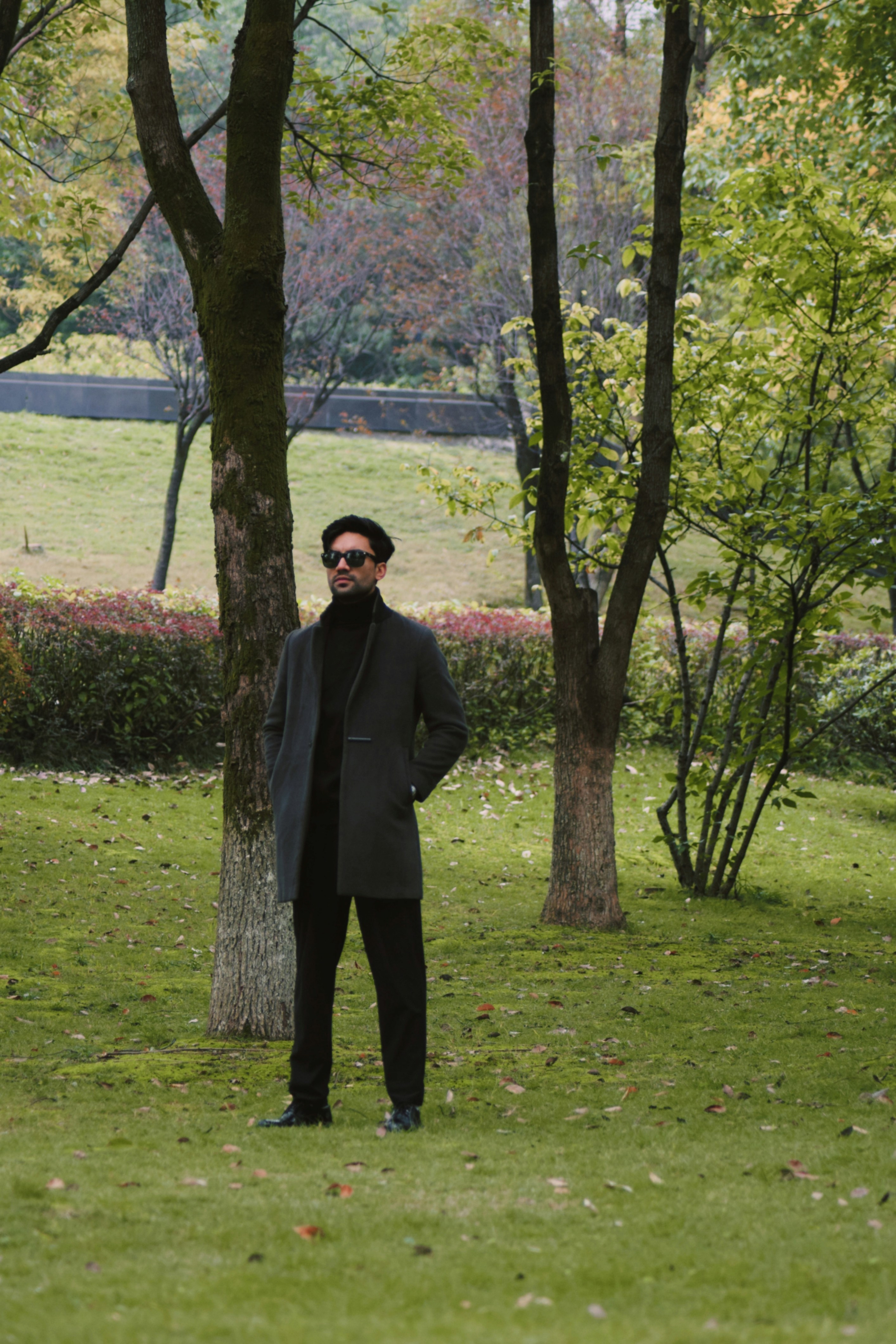 A man standing in the middle of a park