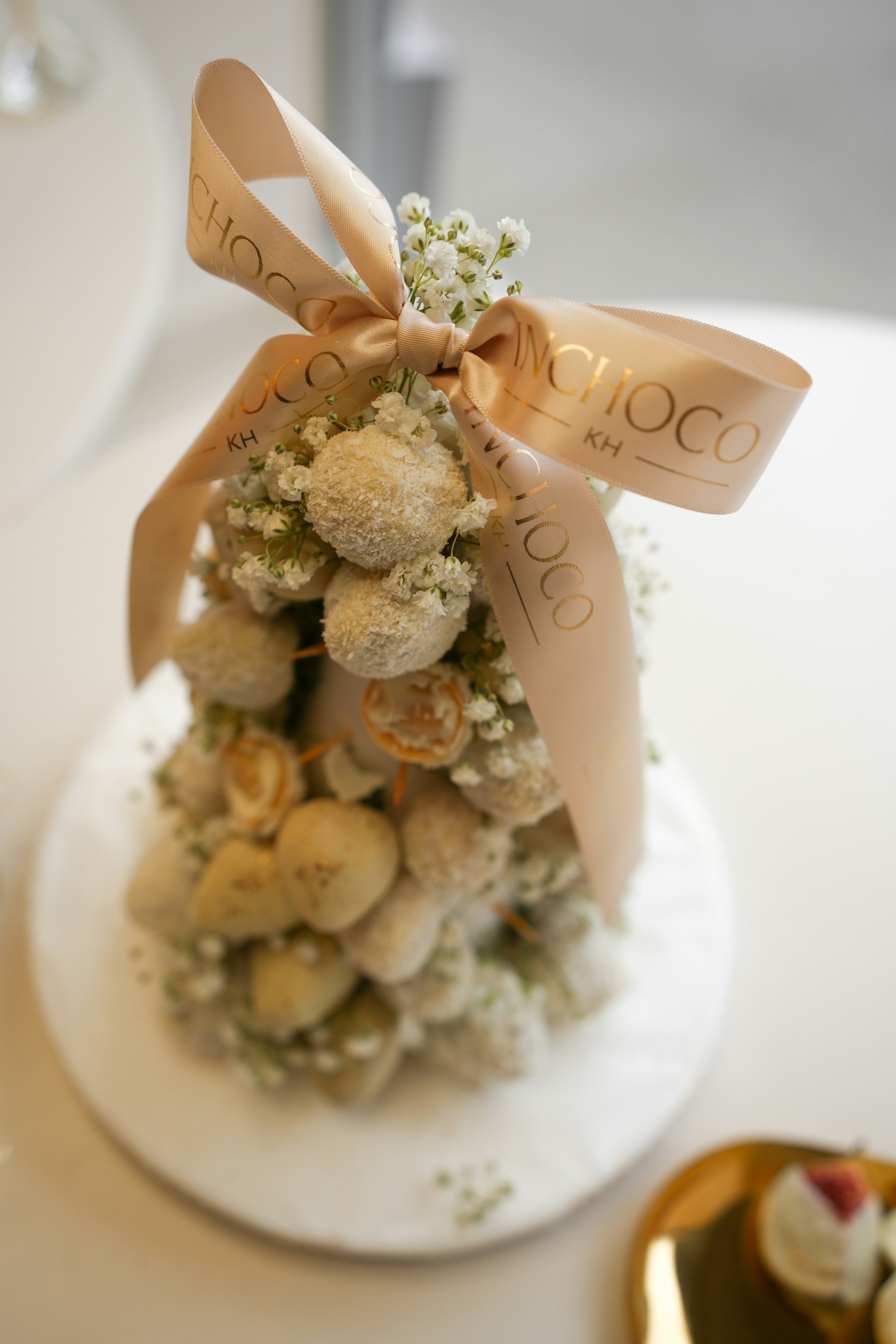 A white table topped with a vase filled with flowers