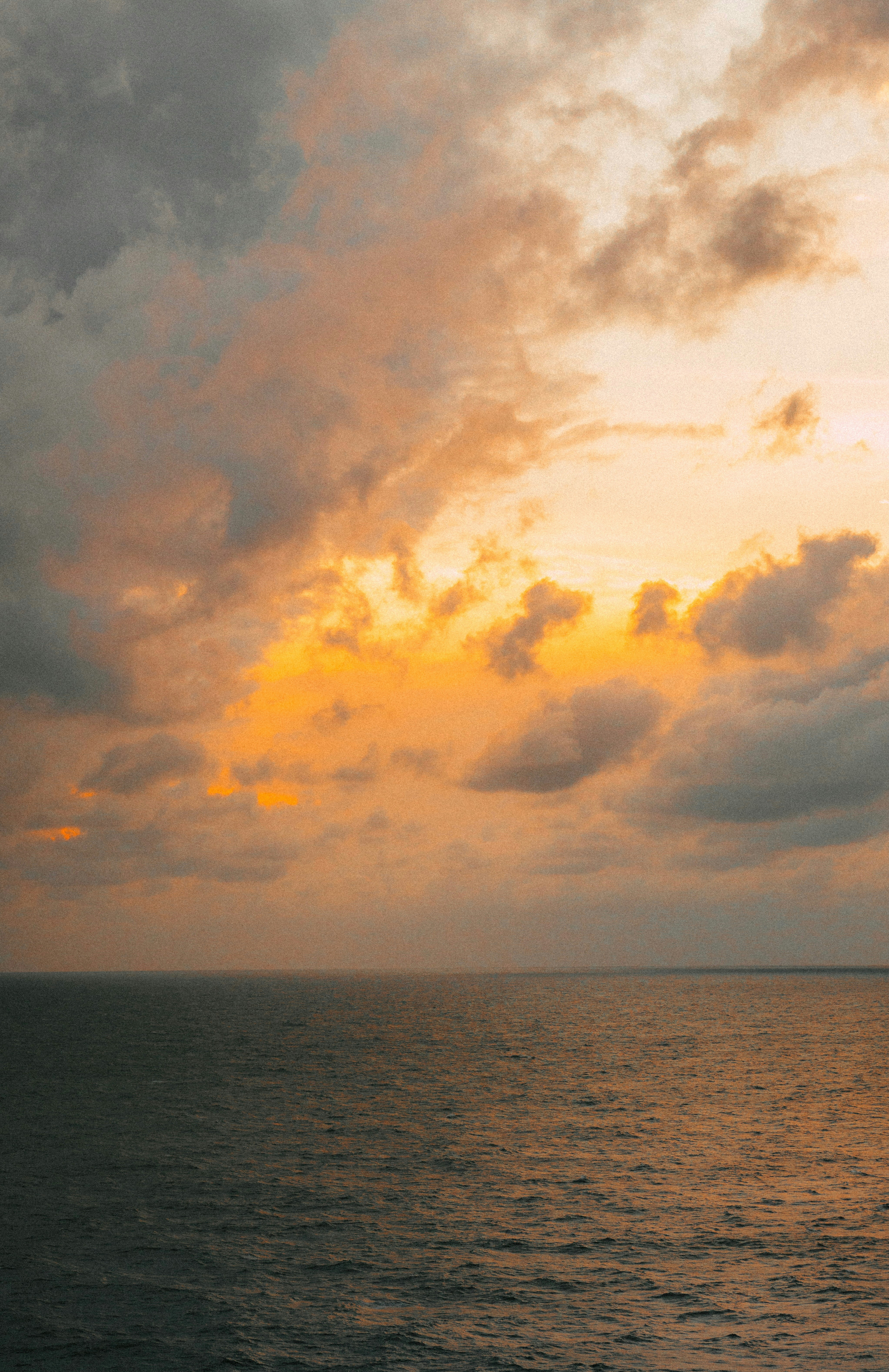 A large body of water under a cloudy sky