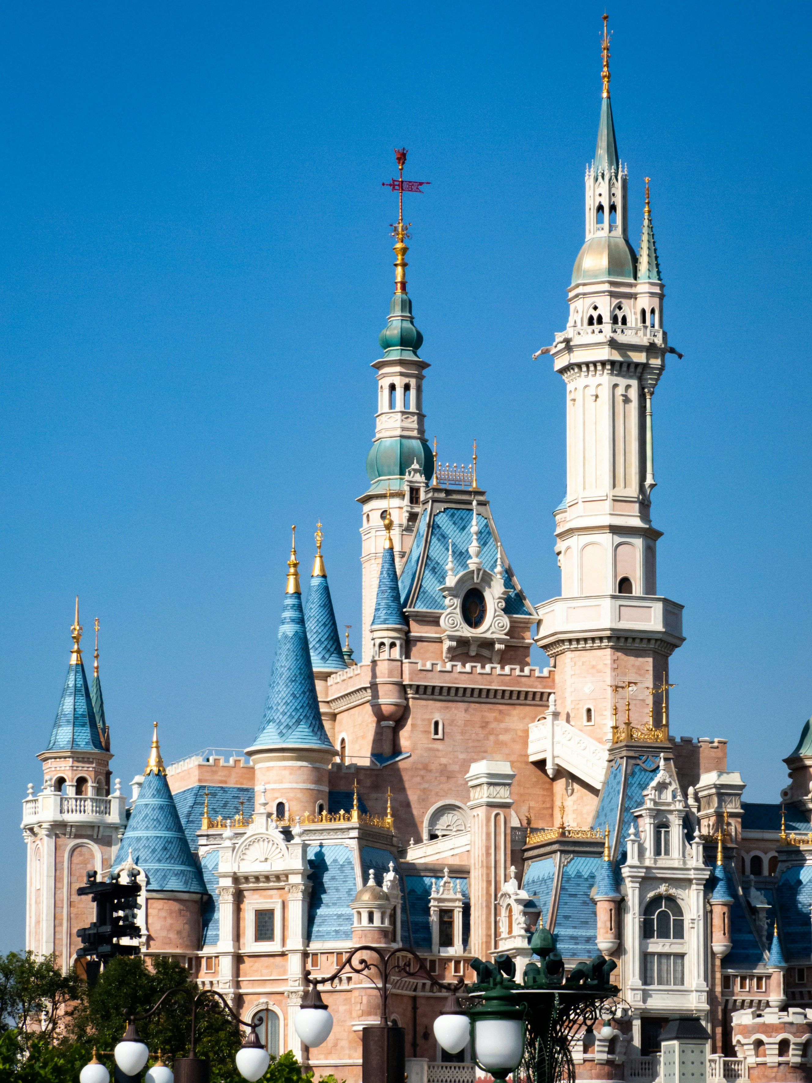 A very tall castle with a clock on it's side