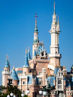 A very tall castle with a clock on it's side