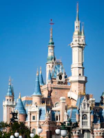 A very tall castle with a clock on it's side