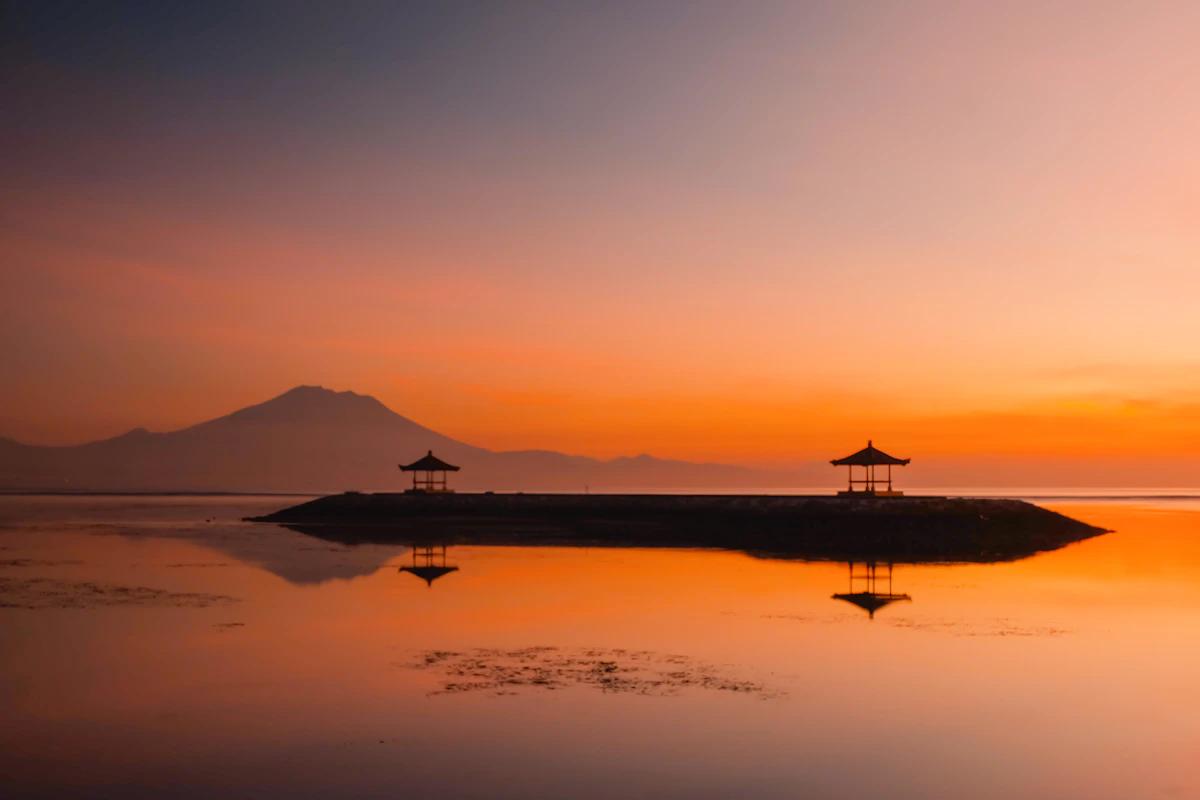 Peaceful sunrise bicycle boardwalk and calm barrier reef shallows in Sanur
