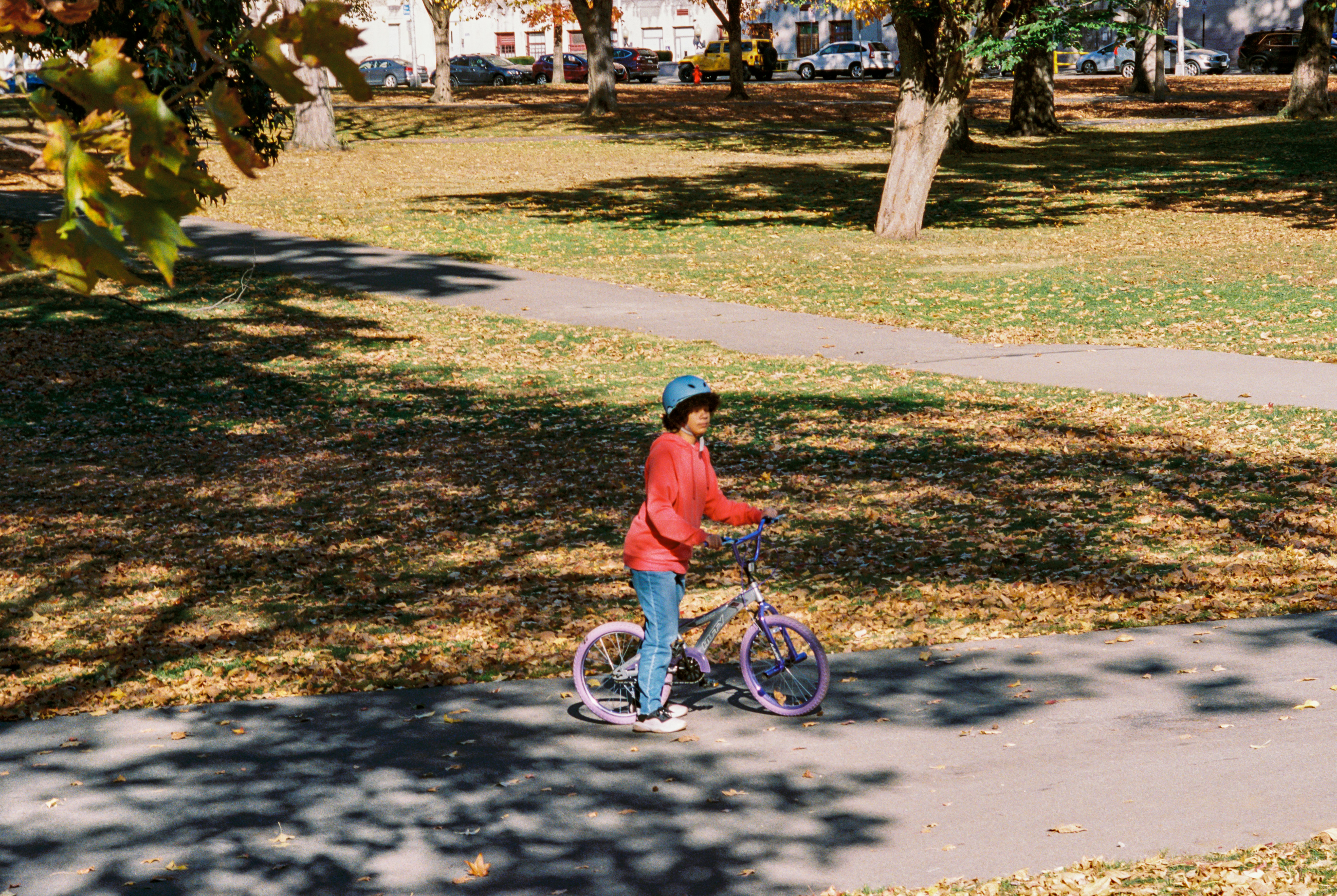 A young boy riding a bike down a sidewalk