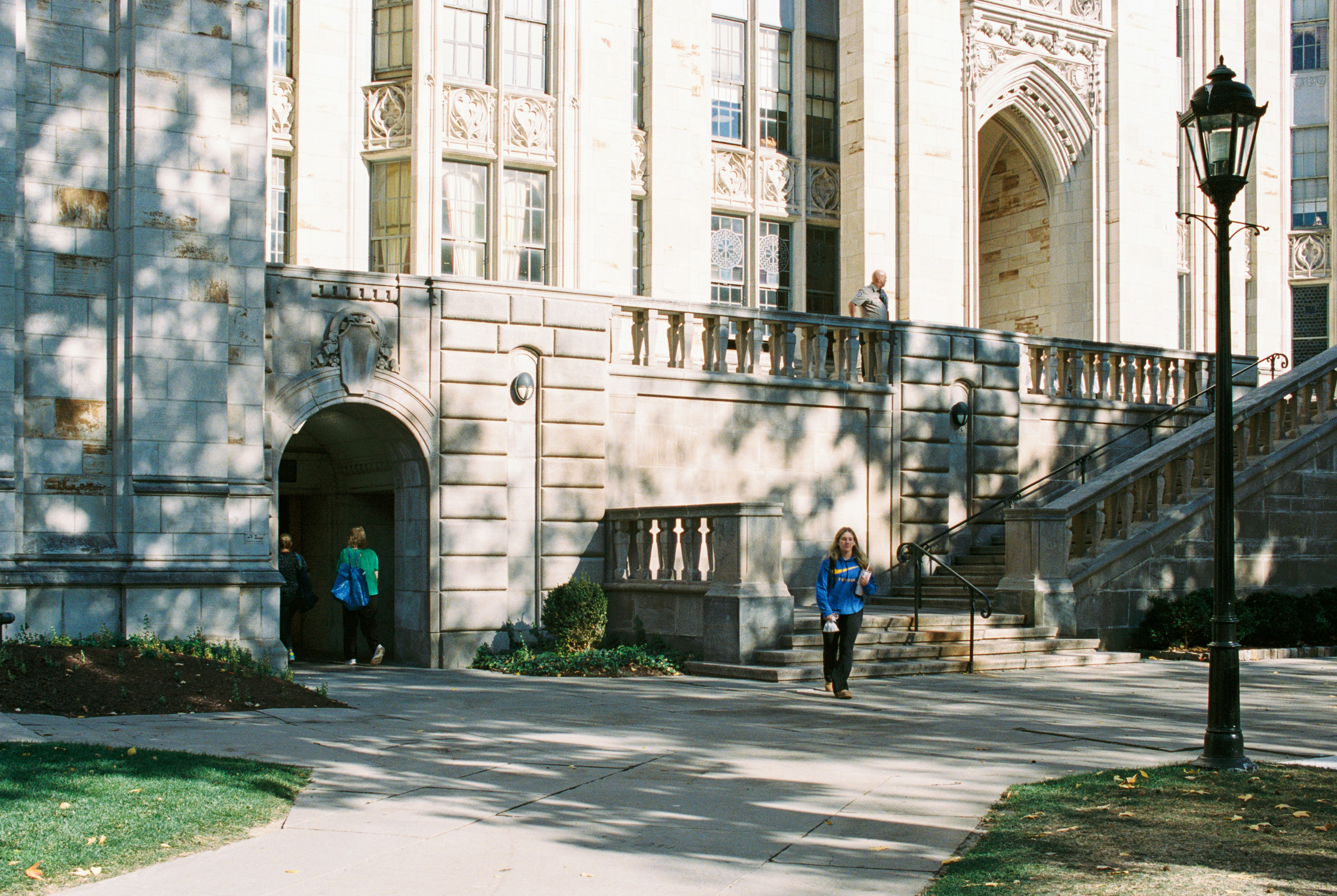 A couple of people that are standing in front of a building
