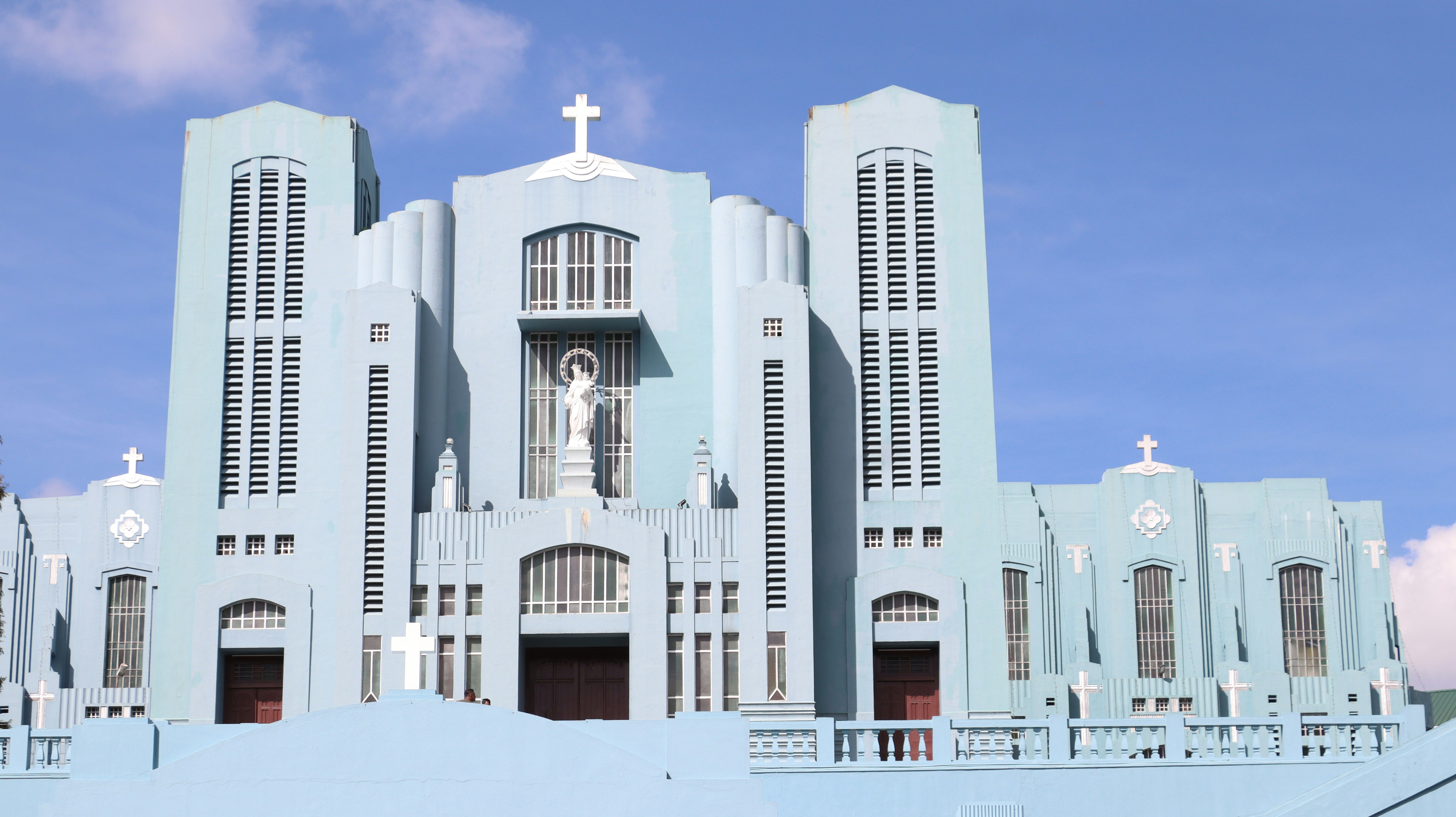 A large white building with a cross on it