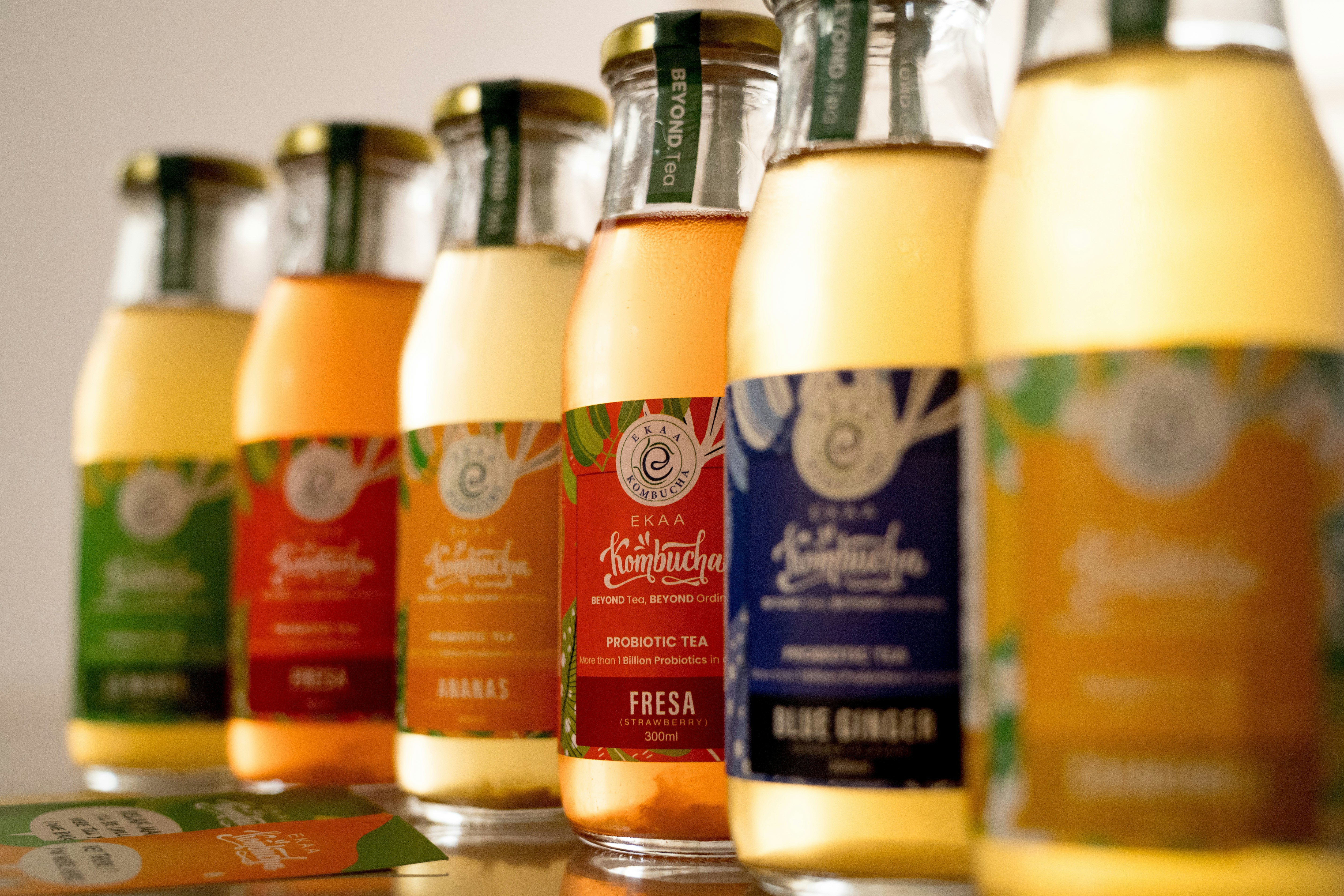A row of bottles of juice sitting on top of a table