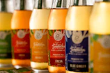 A row of bottles filled with liquid sitting on top of a counter