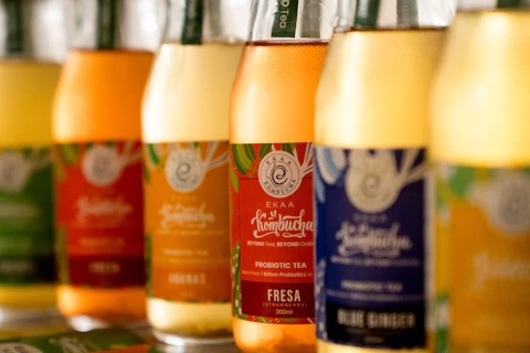 A row of bottles filled with liquid sitting on top of a counter