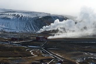 An aerial view of a mountain with steam coming out of it