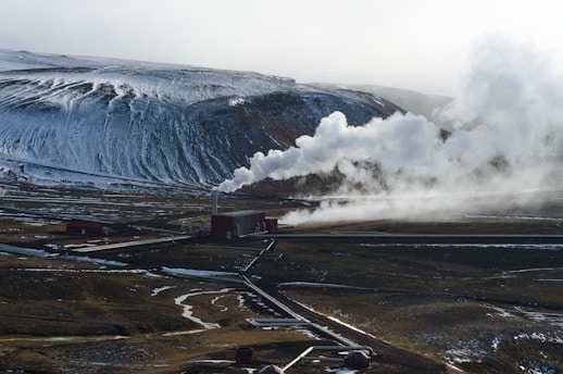 An aerial view of a mountain with steam coming out of it