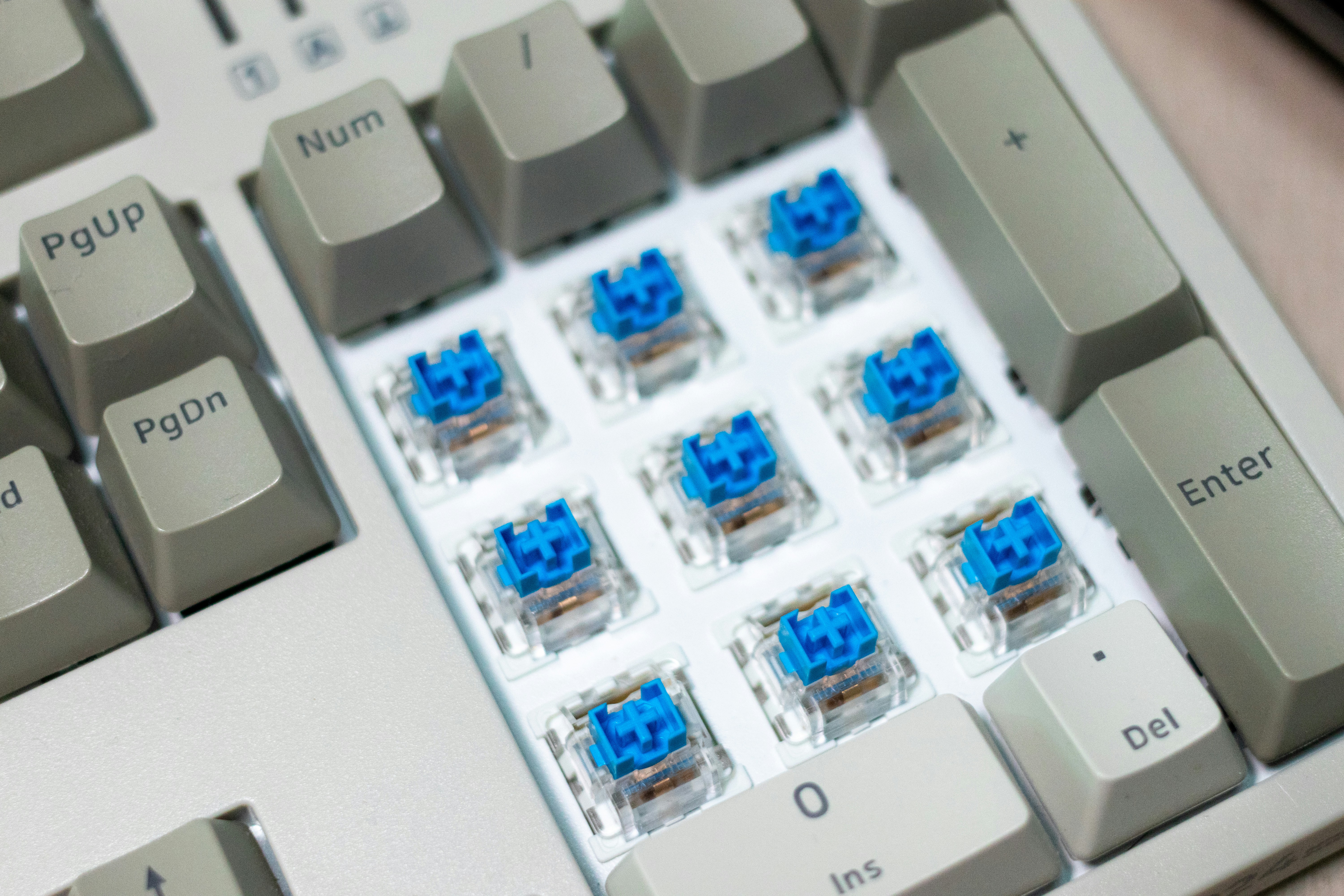 A close up of a computer keyboard with blue keys